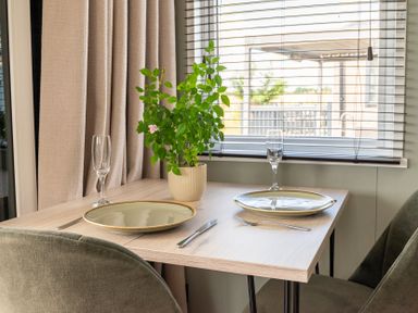 A dining table set with plates and glasses at The Oasis in Great Ayton