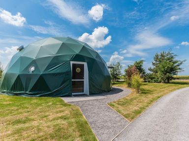 A dome structure with a door beside a pathway at The Dome in Great Ayton