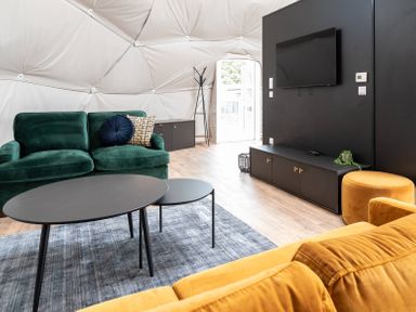 A living room with a green sofa and black coffee table at The Dome in Great Ayton