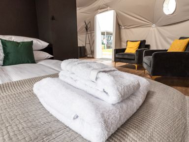 A bedroom with towels on a bed at The Dome in Great Ayton