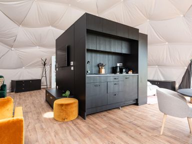 A living room with kitchen area and seating at The Dome (Pet) Great Ayton