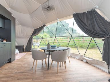 A dining area with a table and chairs at The Dome (Pet) Great Ayton