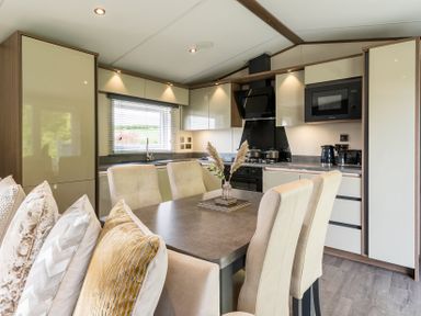 A kitchen with a dining table and cabinets at The Woods in Great Ayton