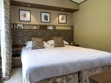 A bedroom with a bed and wall art at The Woods in Great Ayton