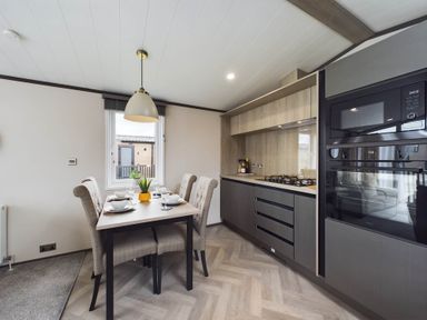 A kitchen with a dining table and chairs at The Woods in Great Ayton
