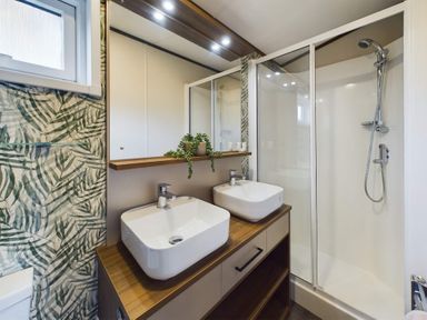 A bathroom with a shower and sinks at The Woods in Great Ayton