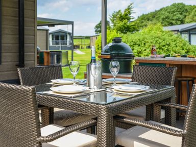 An outdoor dining area with a table and chairs at The Woods in Great Ayton