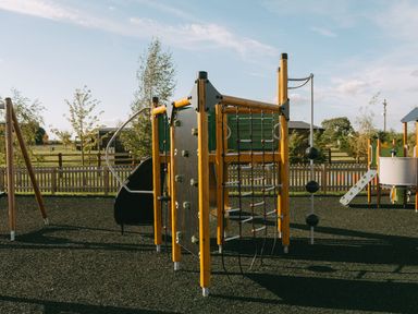 A playground with climbing wall and slide at The Woods in Great Ayton