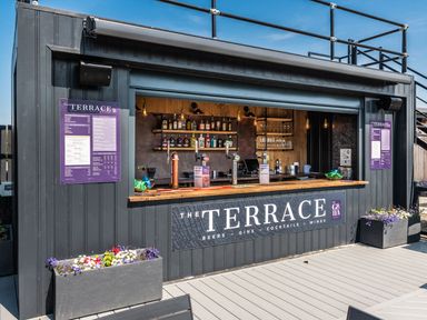 A bar counter with drinks and a menu at The Terrace in Great Ayton