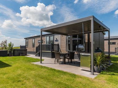 An outdoor seating area with a dining table at The Woods (Pet) Great Ayton