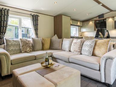 A living room with a sofa, cushions, and coffee table at The Woods (Pet) Great Ayton
