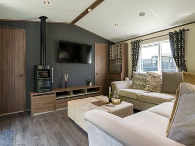 A living room with a sofa and television at The Woods (Pet) in Great Ayton