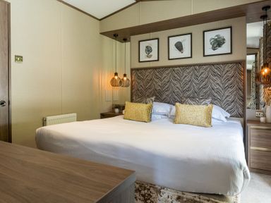 A bedroom with a bed and wall art at The Woods (Pet) in Great Ayton