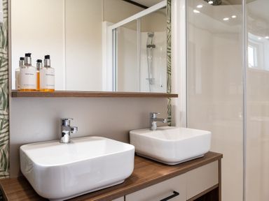 A bathroom with two washbasins and a shower at The Woods (Pet) in Great Ayton
