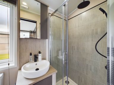 A bathroom with a shower and sink at The Woods (Pet) Great Ayton