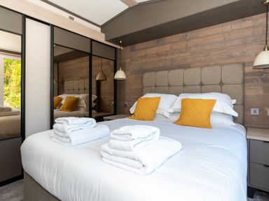 A bedroom with a bed and pillows at The Woods (Pet) Great Ayton