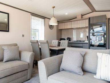 A living room with a couch and dining area at The Woods (Pet) Great Ayton