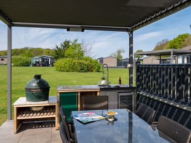 An outdoor dining area with a grill and a table at Leven (Pet) Great Ayton