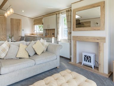 A living room with a sofa and kitchen units at Leven (Pet) Great Ayton