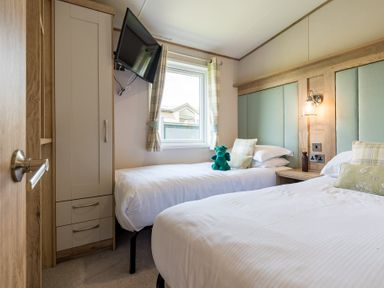 A bedroom with two beds and a television at Leven (Pet) in Great Ayton