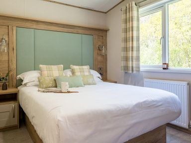 A bedroom with a bed and window at Leven (Pet) Great Ayton