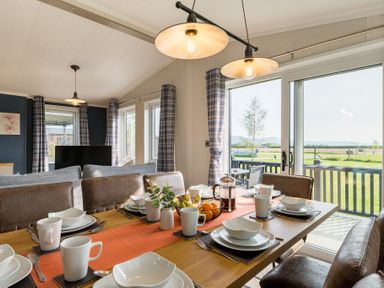 A dining room with a table set for meals at Roseberry in Great Ayton