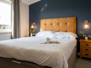 A bedroom with a bed and nightstand at Roseberry in Great Ayton