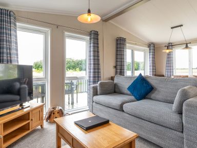 A living room with a sofa and television at Roseberry in Great Ayton