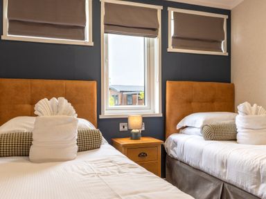 A bedroom with two beds and a nightstand at Roseberry in Great Ayton