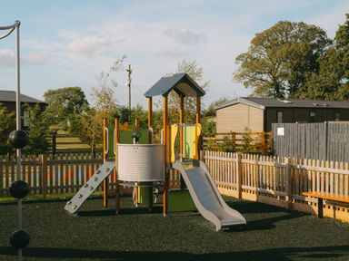 A playground with a climbing frame and slide at Roseberry in Great Ayton