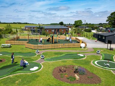 An outdoor playground with a mini golf course and play equipment at Roseberry, Great Ayton