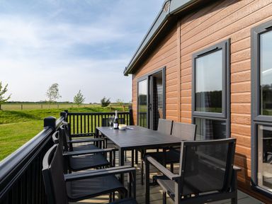 A dining area on a deck with chairs and a table at Roseberry (Pet) Great Ayton