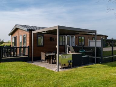 An outdoor area with a dining table and cooking grill at Roseberry (Pet) in Great Ayton