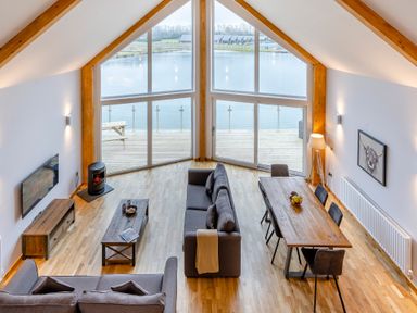 A living room with a sofa and dining table at Tranquillity 3 (Pet) Carnforth