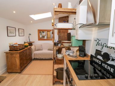A kitchen with a sofa and countertop at Flat 4 in Evesham