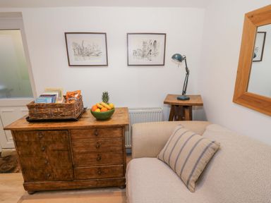 A living room with a sofa and a coffee table at Flat 4 in Evesham