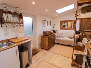 A kitchen with a sink a cabinet and a table at Flat 4 Evesham