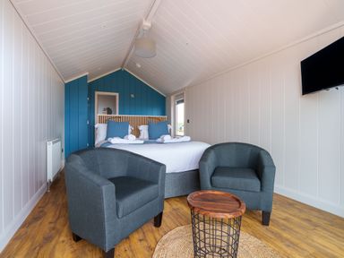 A bedroom with a bed and seating area at The Grays in North Berwick