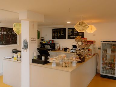 A cafe counter with a menu board and coffee machine at The Grays in North Berwick