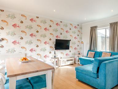 A living room with a sofa and table at 4C2 Summerleaze Garden Cottage 2 Spa in Bude