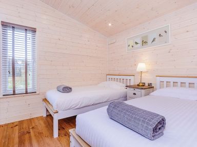 A bedroom with two beds and a bedside table at Hurricane Lodge Fair Oak