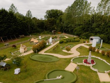 A mini golf course with pathways and greenery at Hurricane Lodge in Fair Oak