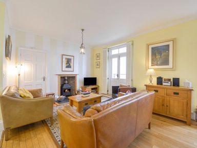 A living room with sofas and a fireplace at The Old Signal House in Torpoint