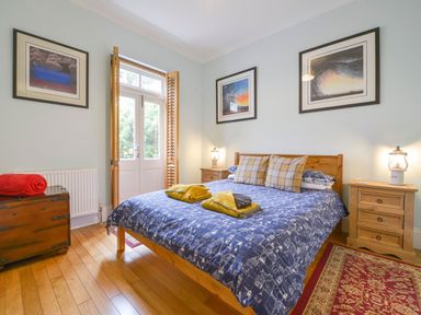 A bedroom with a bed and bedside tables at The Old Signal House in Torpoint
