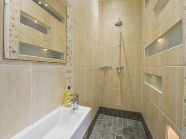 A bathroom with a shower and washbasin at The Old Signal House, Torpoint