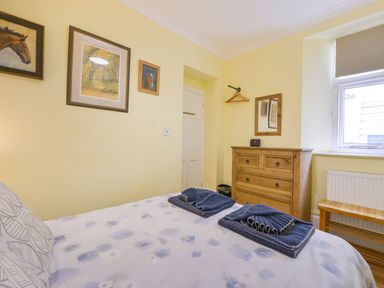 A bedroom with a bed and drawers at The Old Signal House Torpoint