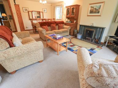 A living room with a sofa arrangement and dining area at Thrang View in Chapel Stile
