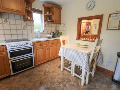 A kitchen with table and chairs at Thrang View in Chapel Stile