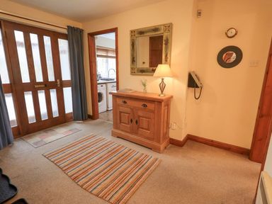 A hallway with a console table and mirror at Thrang View in Chapel Stile