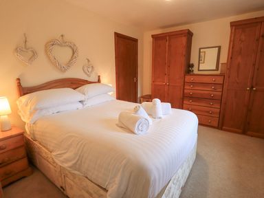 A bedroom with a bed and wooden furniture at Thrang View in Chapel Stile